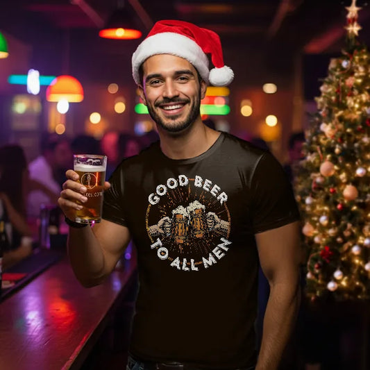 Man wearing a Santa hat and 'Good Beer to All Men' shirt holding a beer in a festive bar setting.