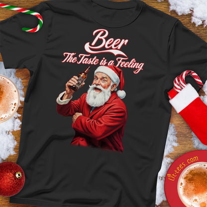 Black Christmas t-shirt with Santa Claus holding a beer and 'Beer: The Taste is a Feeling' text, surrounded by Christmas decorations.