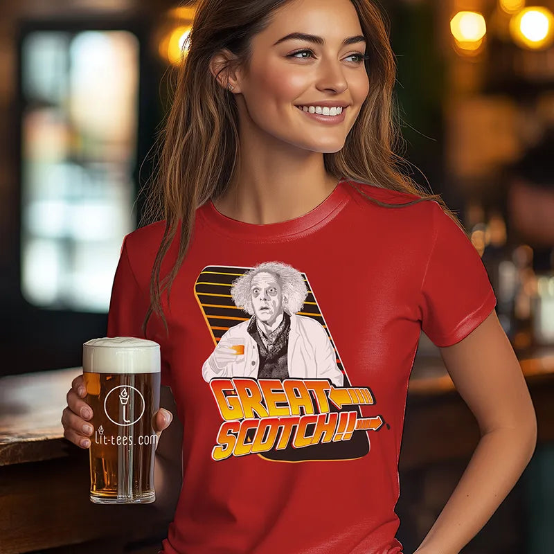Woman wearing a red t-shirt with a graphic design, holding a beer in a bar setting.