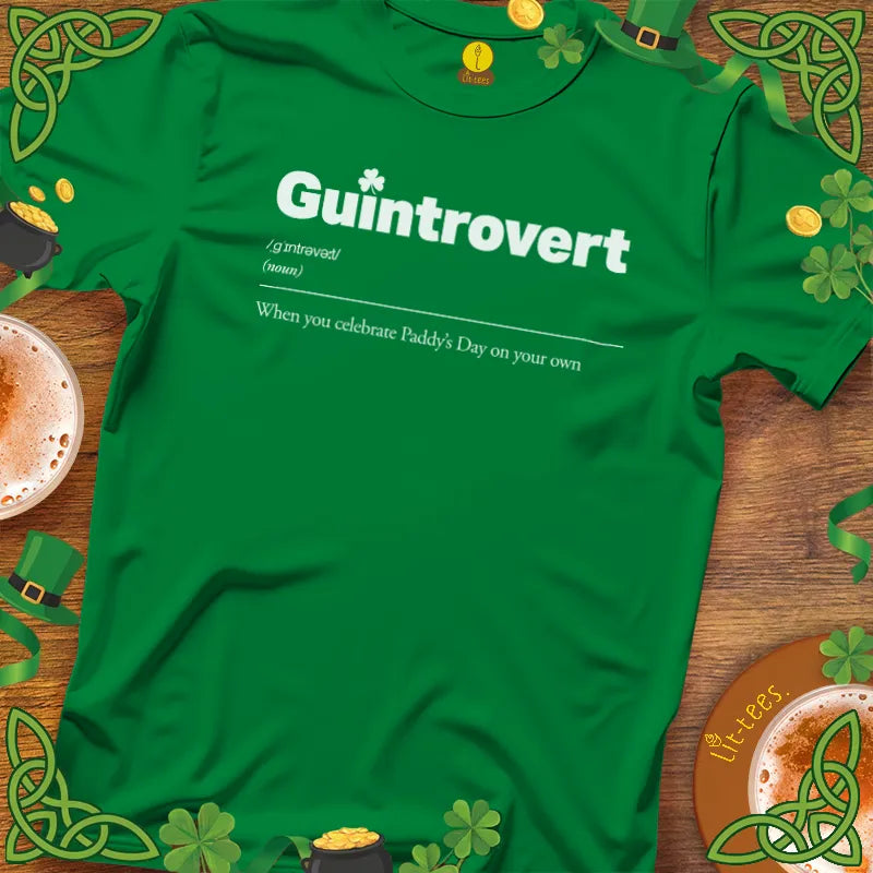 Green t-shirt with 'Guintrovert' text on a wooden surface with St. Patrick's Day decorations.