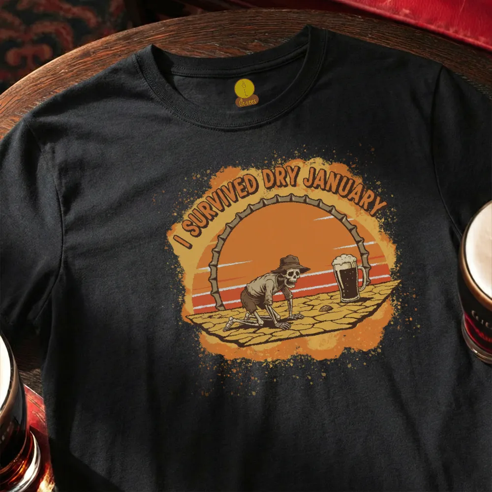 Black t-shirt with a graphic of a skeleton and 'I Survived Dry January' text on a wooden surface.