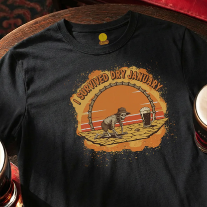Black t-shirt with a graphic of a skeleton and 'I Survived Dry January' text on a wooden surface.