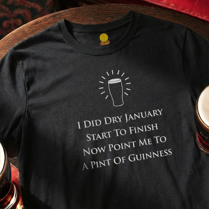 Black t-shirt with humorous text and graphic on a wooden surface with beer cans. Dry January Quatrain