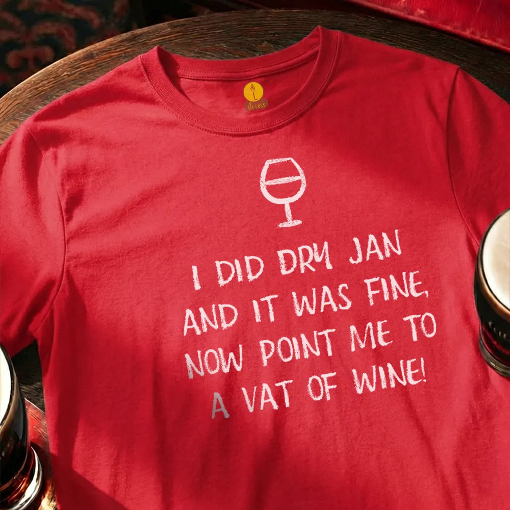 Red t-shirt with humorous text and wine glass graphic on a wooden surface with glasses. Dry January Quatrain