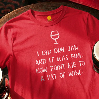 Red t-shirt with humorous text and wine glass graphic on a wooden surface with glasses. Dry January Quatrain