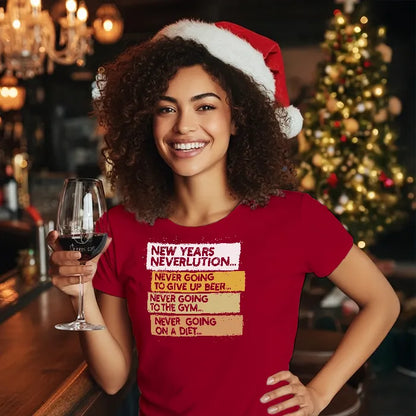 Woman wearing a Christmas themed red shirt with New Year's Neverlution text, holding a glass of wine in a festive setting. Glass has lit-tees.com printed on it.