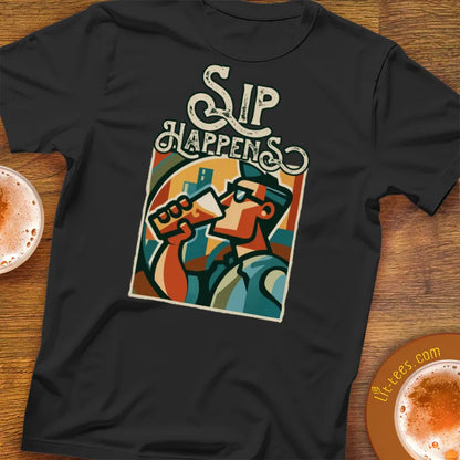 Black t-shirt with 'Sip Happens' graphic design on a wooden surface with coffee cups.